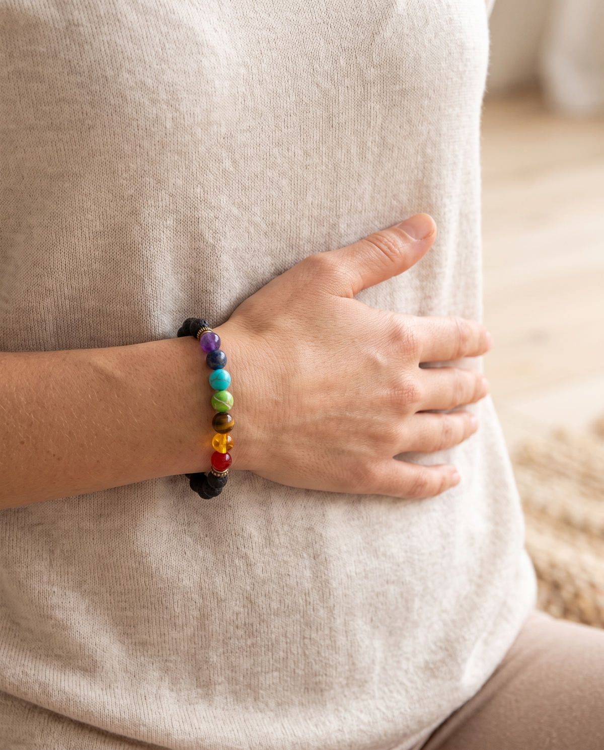Woman wearing the 7 chakra bracelet, hand on her core, healthy and balanced