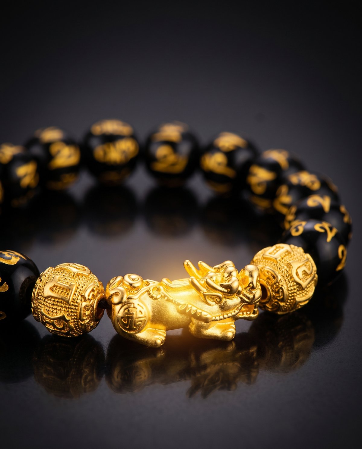 Gold Pi Xiu charm on the Feng Shui bracelet with a warm golden glow
