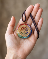 Natural Healing Crystal Necklace held in a woman's hand on its cord
